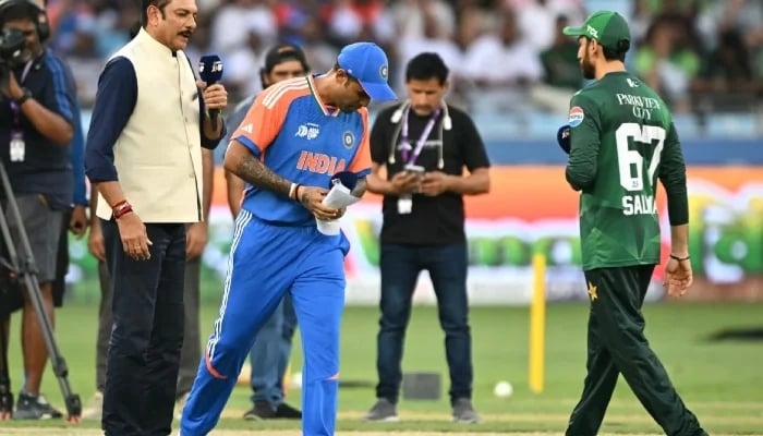 1346845_7651865_asia-cup-2025-final-trophy-shoot_updates India captain Suryakumar Yadav (C) walks away without shaking hands with Pakistan counterpart Salman Agha (R) after the toss for the start of the Asia Cup Super Four contest in Dubai on Sunday, September 21, 2025 — AFP