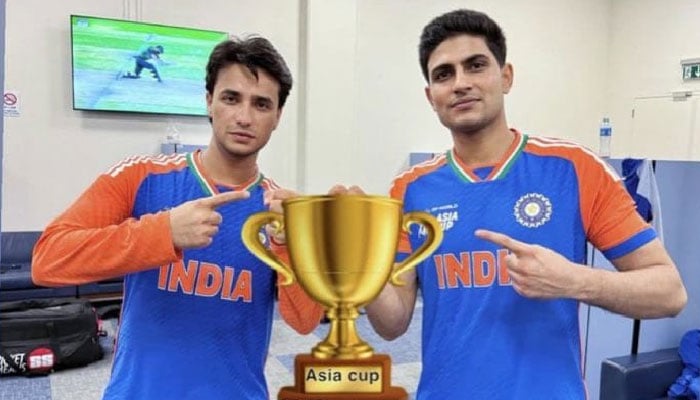 1347209_9312477_team_updates Indian skipper batters Shubman Gill and Abhishek Sharma seen pose for a picture, including a sticker of a trophy to celebrate the Asia Cup 2025 win. — X