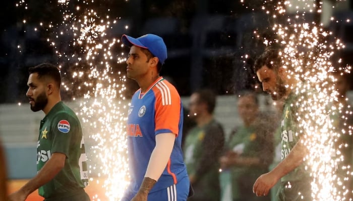 Indias Suryakumar Yadav and Pakistan players walk out before the final of the Asia Cup 2025 at Dubai International Cricket Stadium, September 28, 2025. — Reuters