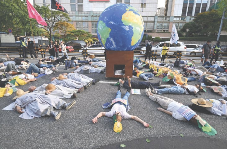 SEOUL: Protesters stage a ‘die-in’ performance during a rally for Climate Justice on Saturday. Tens of thousands of people took to the streets of South Korea’s capital demanding the government set ambitious greenhouse gas reduction targets, just days after President Lee Jae Myung addressed the UNGA, where US President Donald Trump dismissed climate change as ‘the greatest con job’ in the world.—AFP