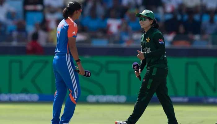 Indian captain Harmanpreet Kaur (left) and Pakistan captain Fatima Sana during the toss time ahead of the Womens T20 World Cup clash at the Dubai International Cricket Stadium in Dubai on October 6, 2024. — AFP