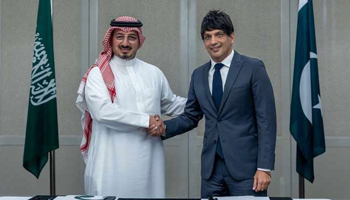 PFF President Mohsin Gilani (right) and SAFF President Yasser Al-Misehal shaking hands after signing agreement. — Reporter