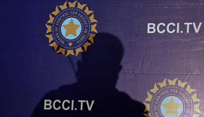 The shadow of a man falls on a backdrop with the logo of the Indias cricket board BCCI before the start of a news conference to announce its cricket teams coach, in Mumbai, India, August 16, 2019.— Reuters