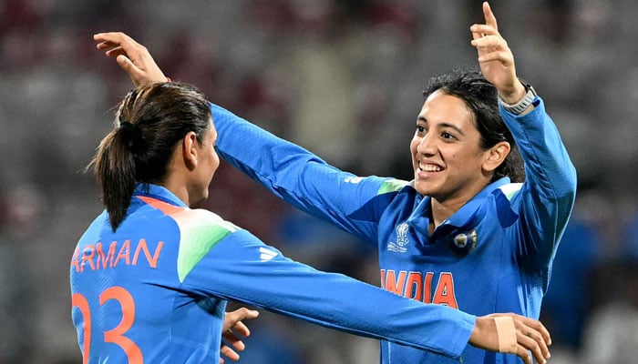 Indias captain Harmanpreet Kaur (L) embraces Smriti Mandhana after their win in the ICC Womens Cricket World Cup 2025 one-day international (ODI) match between India and New Zealand at the DY Patil Stadium in Navi Mumbai on October 23, 2025. — AFP