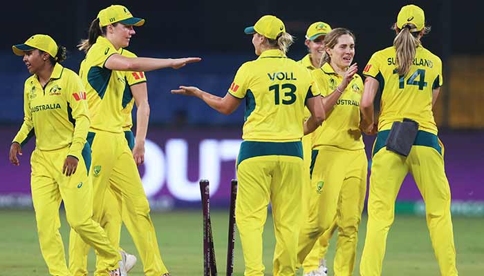 Australias Sophie Molineux and Georgia Voll celebrate with teammates the wicket of Englands Linsey Smith at Holkar Cricket Stadium, Indore, India, October 22, 2025. — Reuters