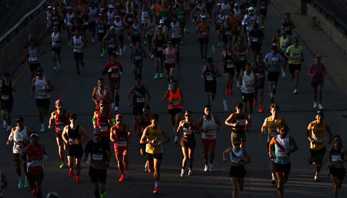 Waves of runners make their way through the 2025 Bank of America Chicago Marathon course in Chicago, Illinois on October 12, 2025. — AFP