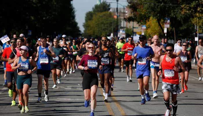 Participants run through the Pilsen neighborhood during the 2025 Chicago Marathon in Chicago, Ilinois, on October 12, 2025. — AFP