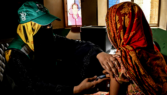 626504_1782875_updates A health worker (left) administers human papillomavirus (HPV) vaccine to a girl in Karachi on September 24, 2025, during a HPV vaccination drive against cervical cancer, most frequently diagnosed in women. — AFP