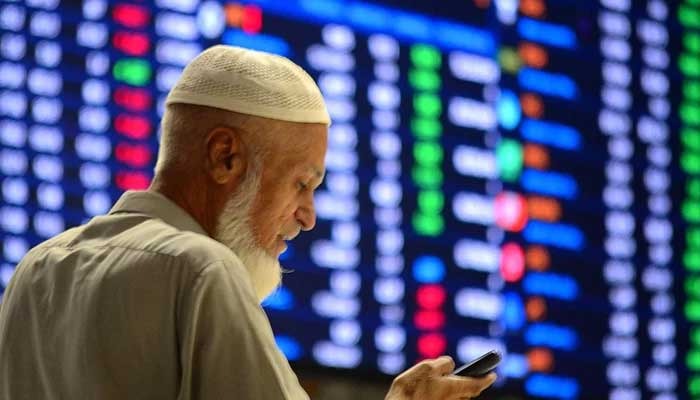627188_7053464_updates A Pakistani stockbroker monitors share prices during a trading session at the PSX in Karachi, on October 17, 2024. — INP