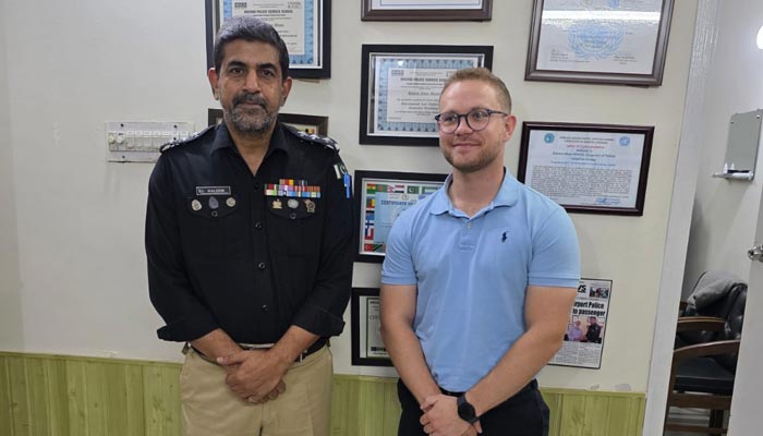 Airport SHO Kaleem Moosa (left) poses with British police officer Duncan Woray in Karachi, in a photo released on October 7, 2025. — Karachi police