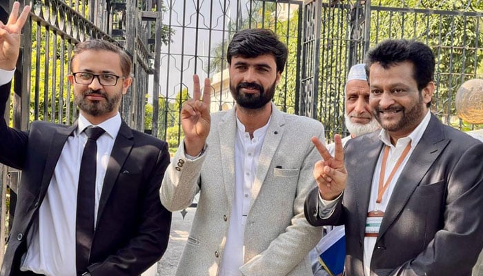 629569_5252120_updates Arshad Khan (centre) and his lawyers flash victory signs outside the Lahore High Court Rawalpindi bench on October 20, 2025. — Arshads team