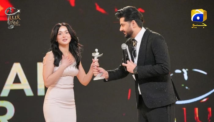 Hania Aamir receives her award for Best Actor (Female) Drama from actor and host Imran Ashraf at the Lux Style Awards in Karachi on December 12, 2025. — LUX Awards